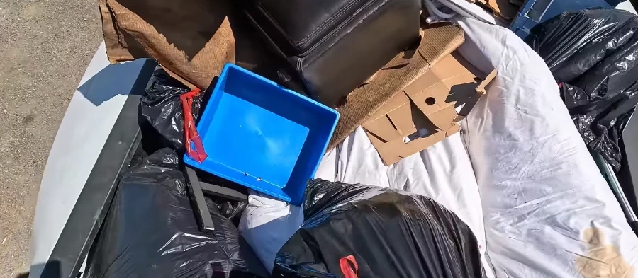 Estate cleanout junk removal in Hemet, CA - bagged items and boxes loaded for haul-away