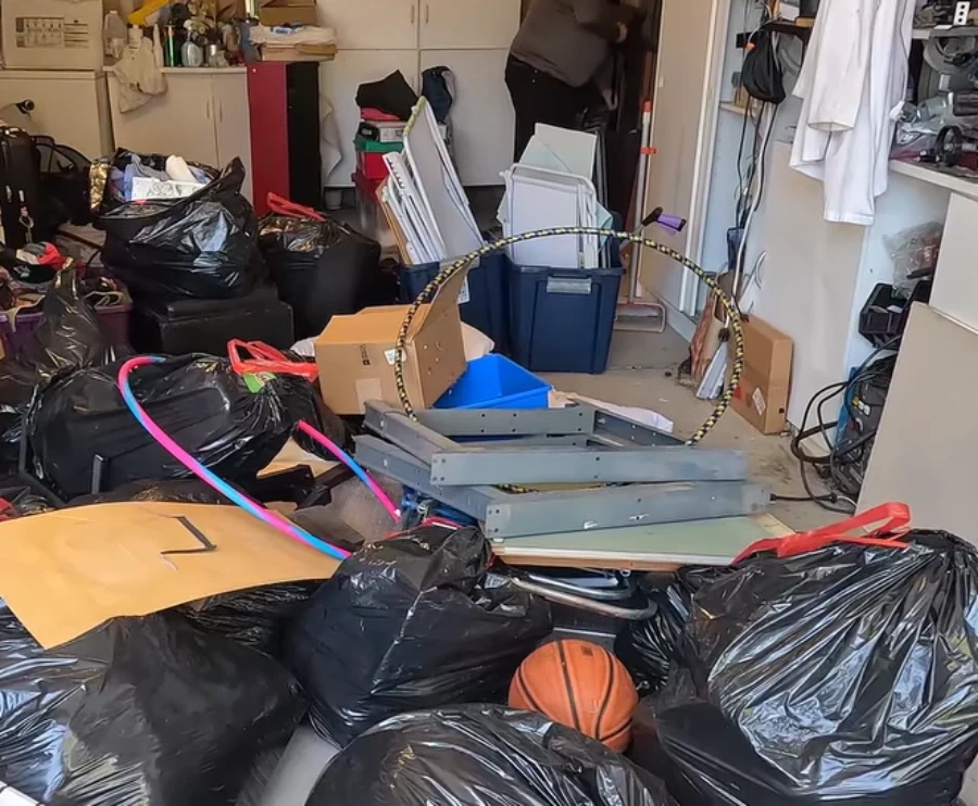 Cluttered garage full of junk before cleanout service in Hemet, CA