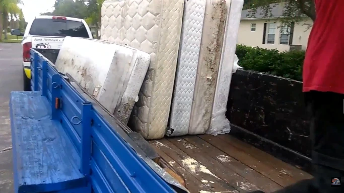 Mattresses loaded into a truck during a furniture removal job in Hemet, CA