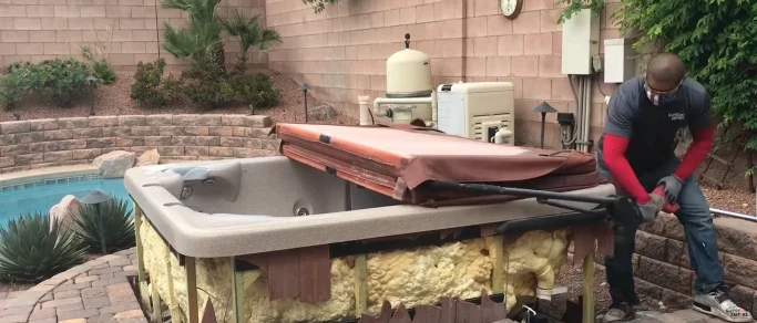 Hot tub being dismantled and removed from a backyard in Hemet, CA